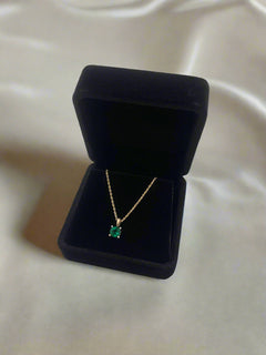 Gold necklace with a green gemstone necklace