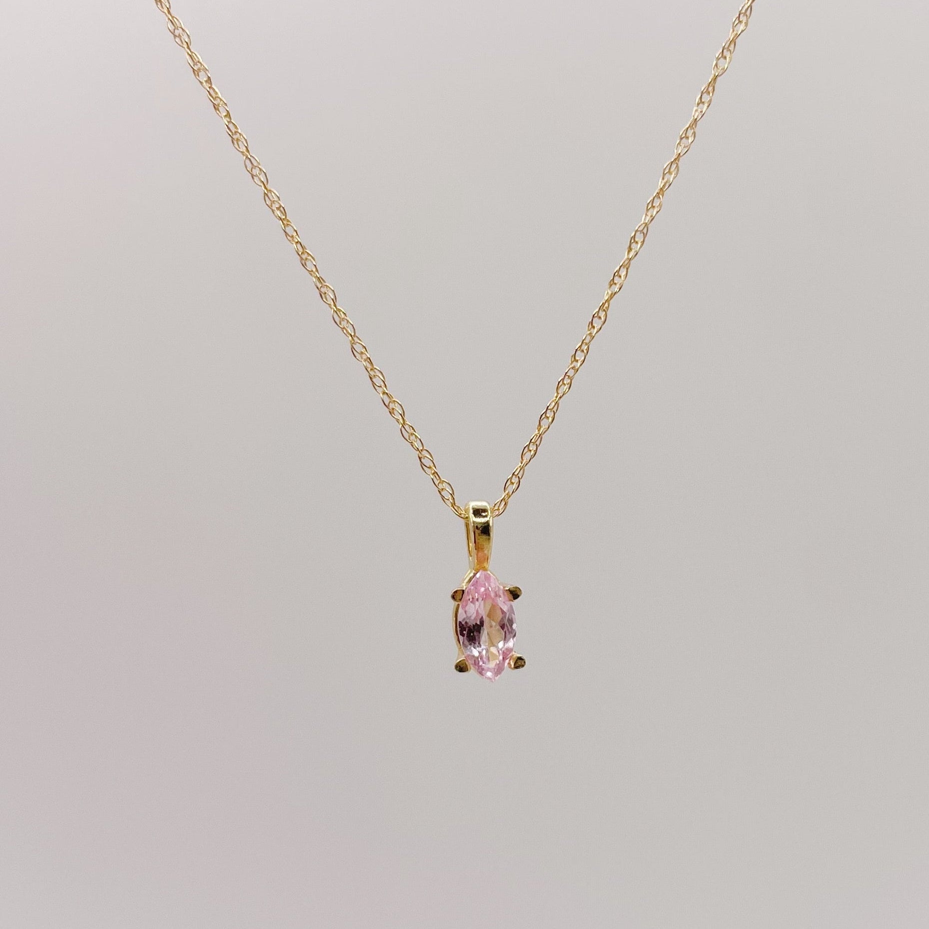 Gold necklace with a pink lab-grown sapphire