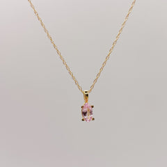 Gold necklace with a pink lab-grown sapphire