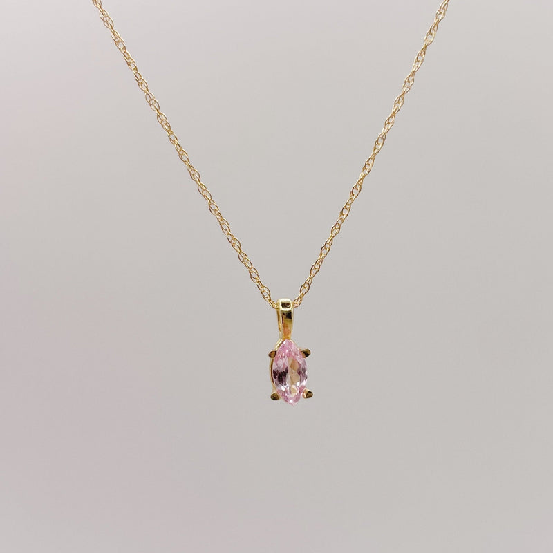 Gold necklace with a pink lab-grown sapphire