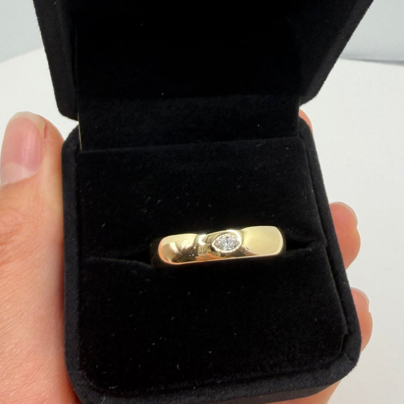 A gold ring with a marquise diamond