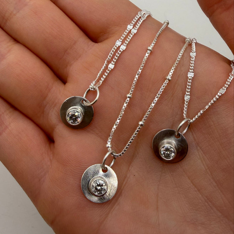 Silver necklaces with circular  diamond pendants 