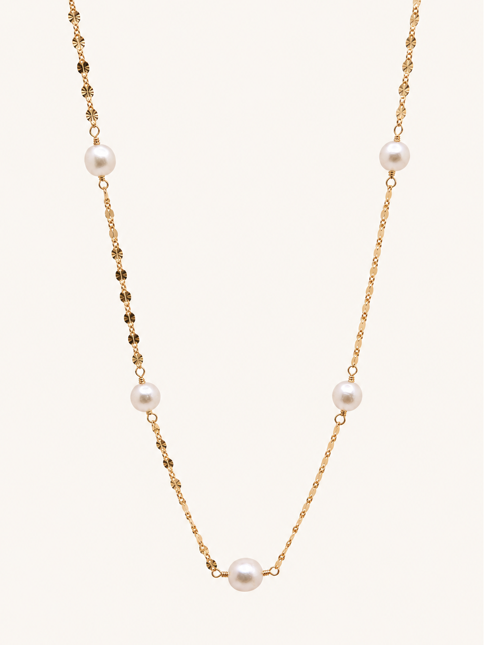 A delicate gold chain necklace featuring five evenly spaced white freshwater pearls