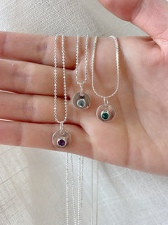 Three silver necklaces with gemstone pendants 